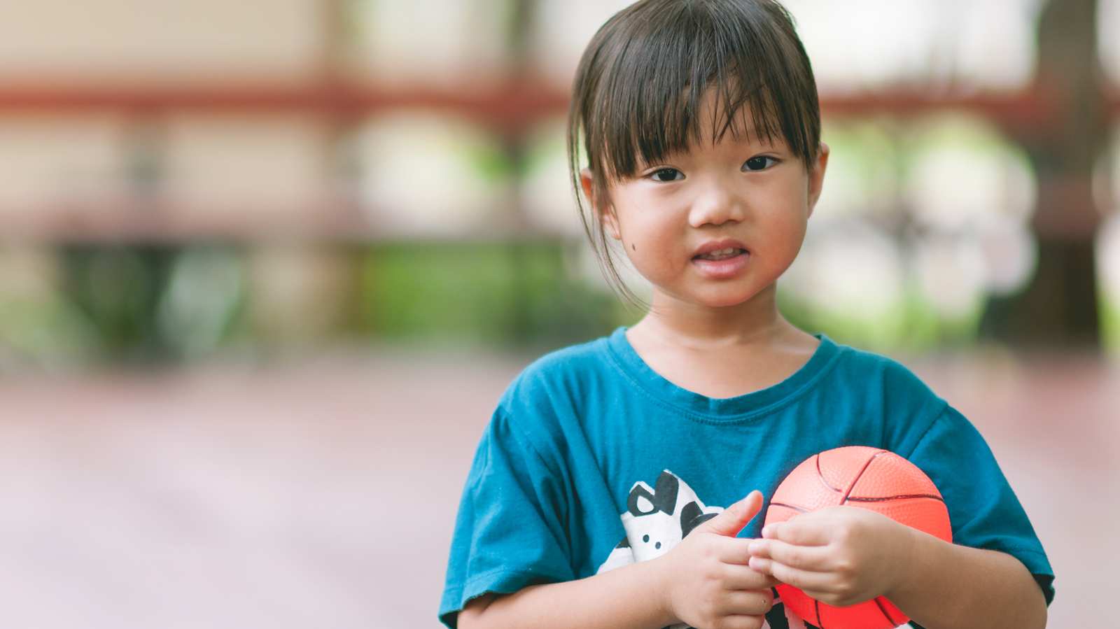 This group of boys stopped their basketball game to play with a two-year-old who ran onto their court