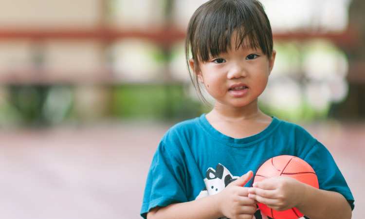 Post thumbnail of This group of boys stopped their basketball game to play with a two-year-old who ran onto their court